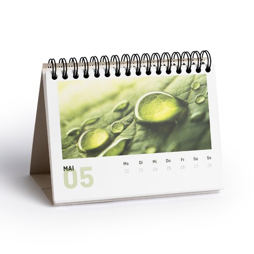 Paper desk calendar with stand and spiral binding.