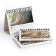 Paper desk calendar with spiral binding.