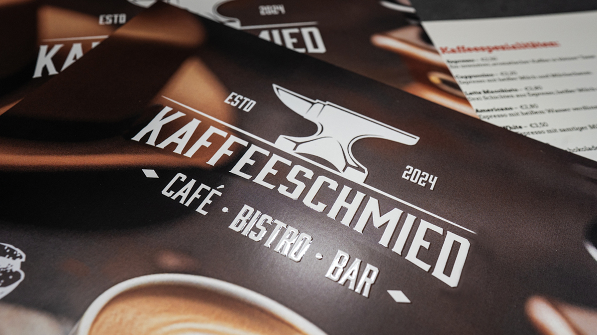 Image Close-up of a caf� flyer with raised, glossy relief varnish on the logo and lettering
